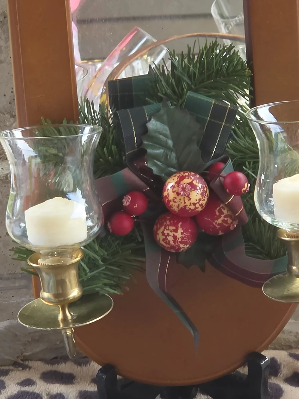 Wall-Mounted Brown Mirror Candle Sconce with Holiday Greenery